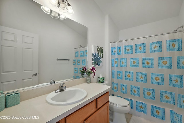 bathroom with vanity, toilet, and curtained shower