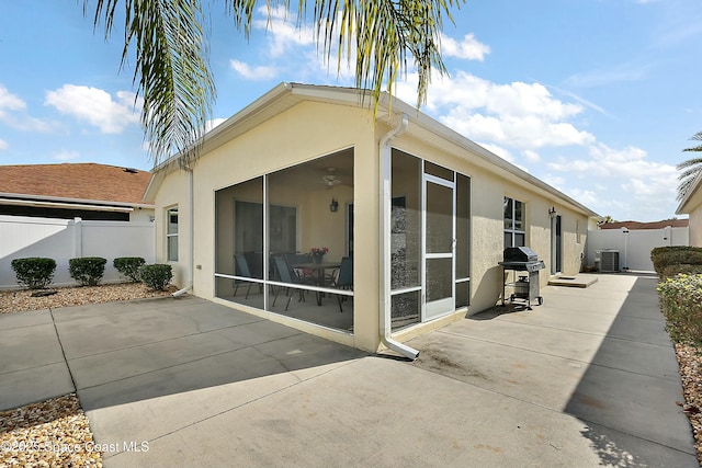 view of property exterior with a sunroom, central AC, ceiling fan, and a patio area