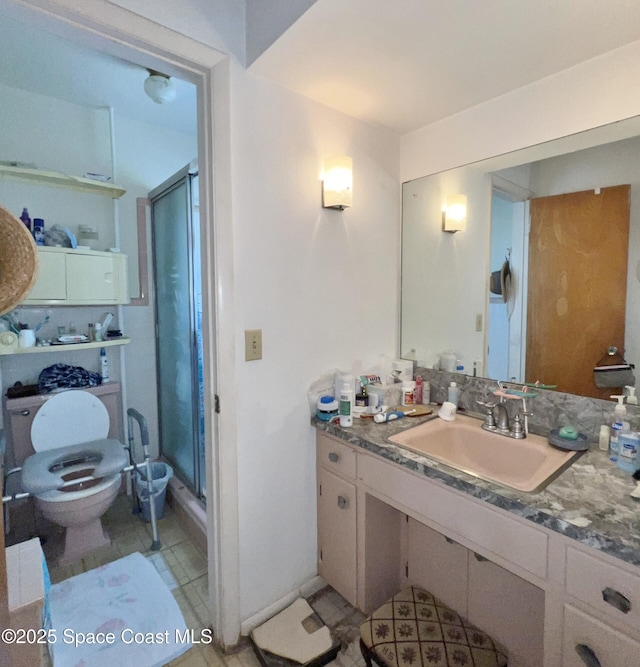 bathroom featuring vanity, a shower with shower door, tile patterned floors, and toilet