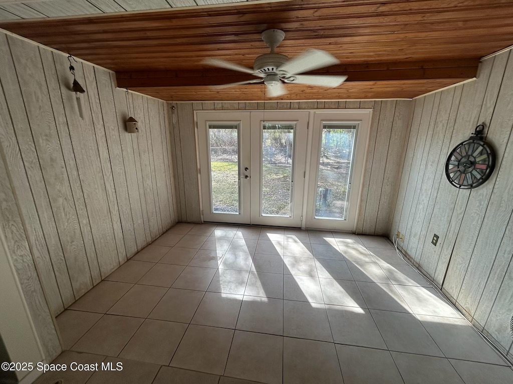 interior space featuring light tile patterned flooring, wooden ceiling, and french doors