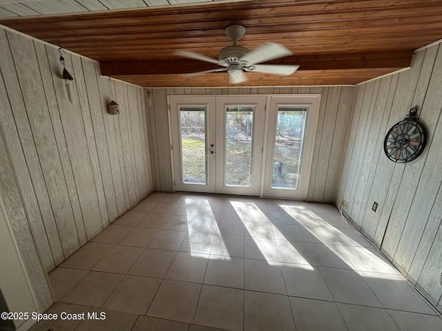 interior space featuring light tile patterned flooring, wooden ceiling, and french doors