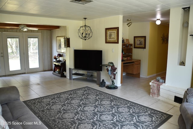 423 Longfellow Blvd, Lakeland, FL 33803 - living area featuring light tile patterned floors, a ceiling fan, baseboards, and wood walls