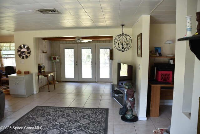 423 Longfellow Blvd, Lakeland, FL 33803 - foyer entrance with light tile patterned flooring, a chandelier, and ceiling fan
