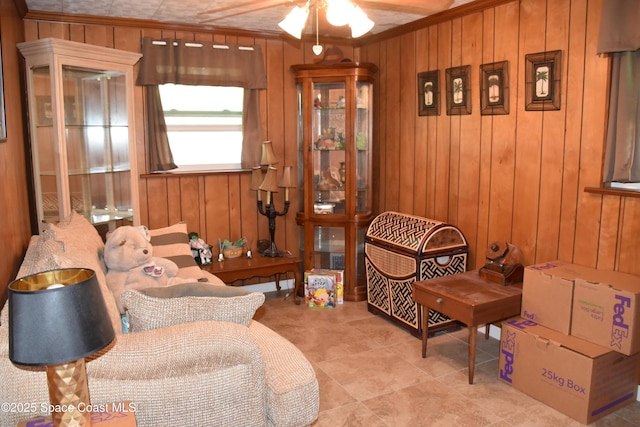 423 Longfellow Blvd, Lakeland, FL 33803 - living area with ornamental molding, wood walls, a ceiling fan, and tile patterned flooring