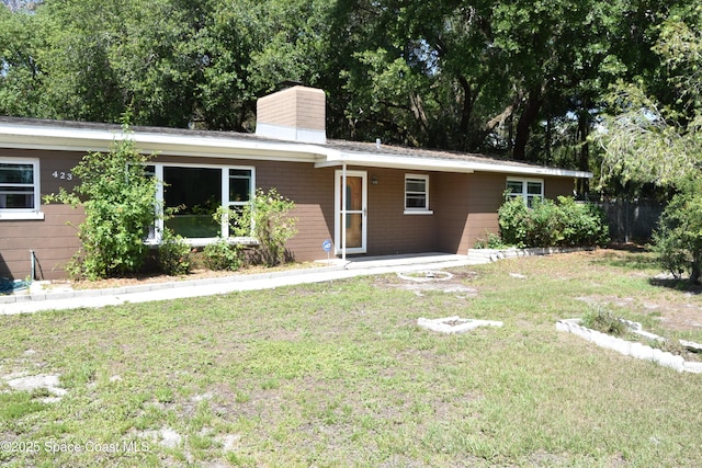 423 Longfellow Blvd, Lakeland, FL 33803 - single story home featuring a chimney and a front lawn