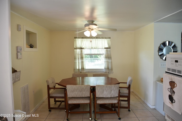 423 Longfellow Blvd, Lakeland, FL 33803 - dining room featuring a ceiling fan, light tile patterned flooring, and crown molding