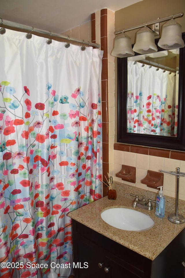 423 Longfellow Blvd, Lakeland, FL 33803 - bathroom with vanity, decorative backsplash, and a shower with shower curtain