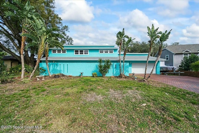 view of front of property with a garage and a front yard