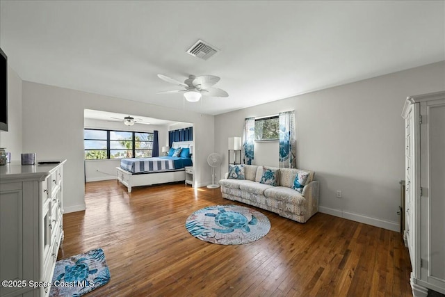 living room with plenty of natural light, hardwood / wood-style floors, and ceiling fan