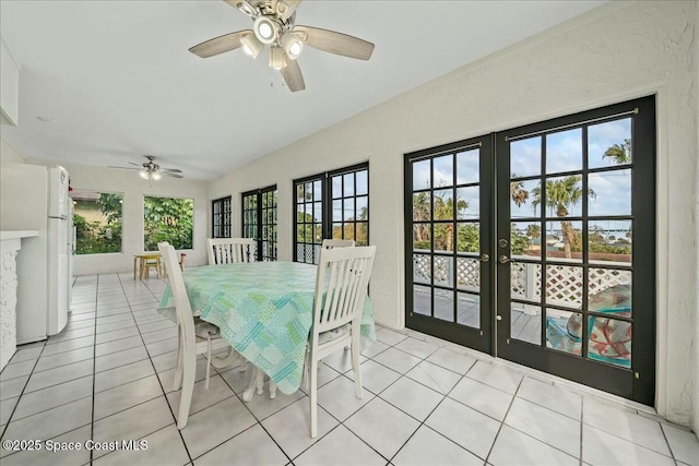 unfurnished dining area with light tile patterned floors, ceiling fan, and french doors