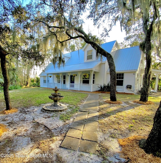 view of front of home with covered porch and a front yard