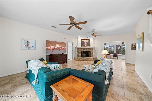 tiled living room with ceiling fan