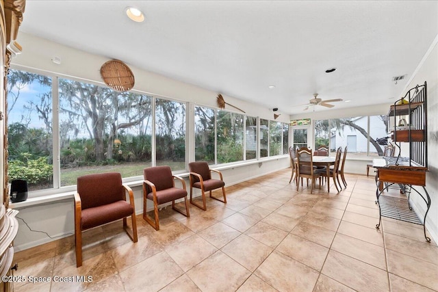 sunroom with a wealth of natural light and ceiling fan