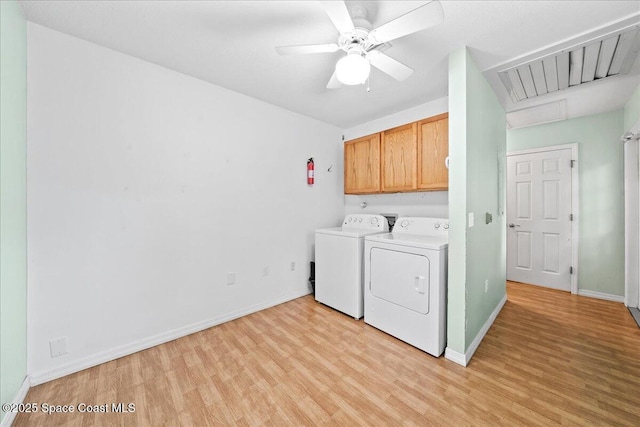 washroom featuring cabinets, ceiling fan, independent washer and dryer, and light hardwood / wood-style flooring