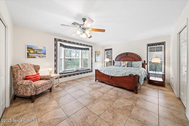 tiled bedroom with ceiling fan