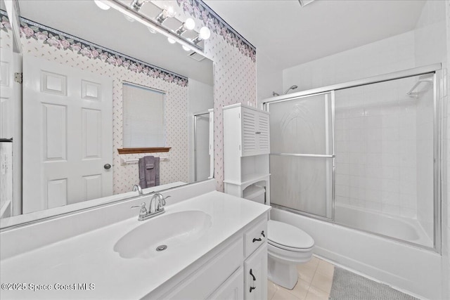 full bathroom with shower / bath combination with glass door, vanity, toilet, and tile patterned flooring