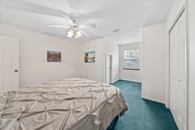 bedroom with dark colored carpet, ceiling fan, and a closet