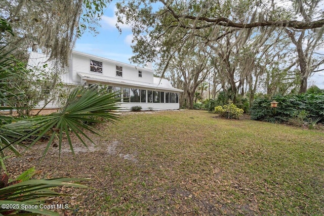 view of yard featuring a sunroom