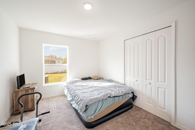 bedroom featuring light carpet and a closet