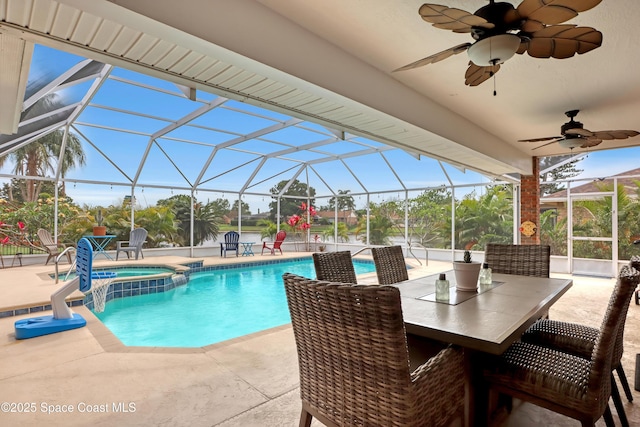 view of pool with a lanai, a patio area, ceiling fan, and an in ground hot tub