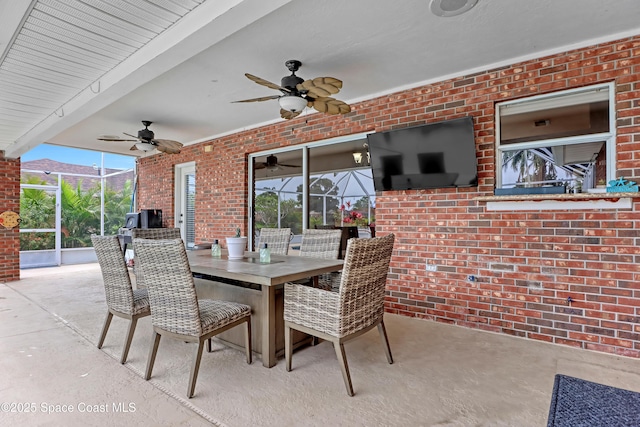 view of patio / terrace featuring a lanai and ceiling fan