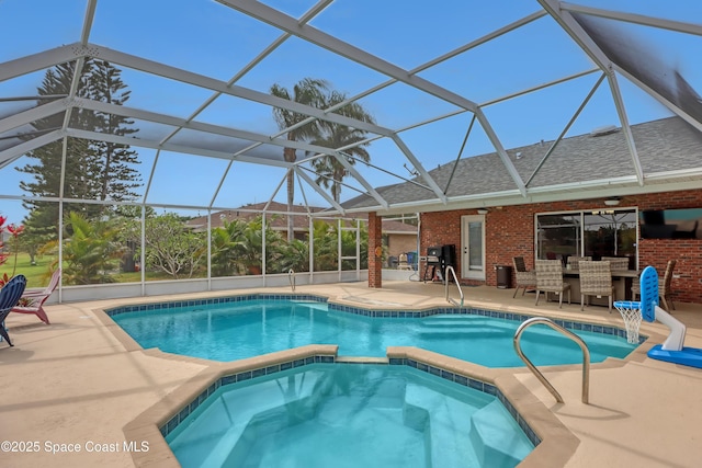 view of swimming pool featuring an in ground hot tub, an outdoor bar, glass enclosure, and a patio