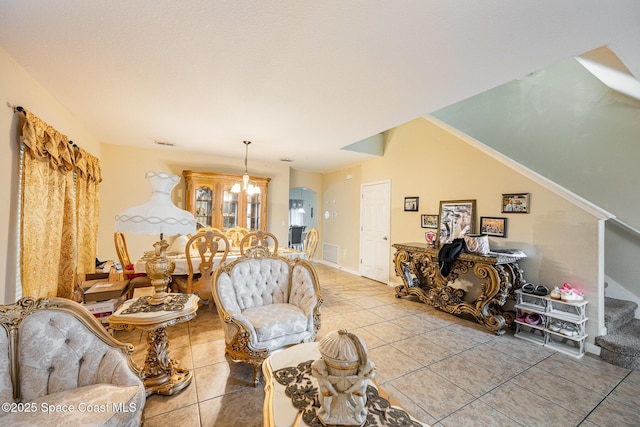 tiled living room featuring a chandelier