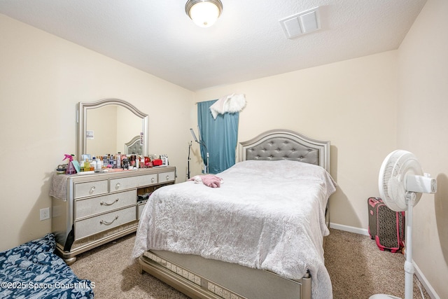 bedroom featuring carpet floors and a textured ceiling