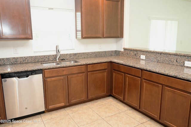 1545 Litchfield Dr, Melbourne, FL 32904 - kitchen featuring stainless steel dishwasher, a sink, light stone counters, and light tile patterned flooring