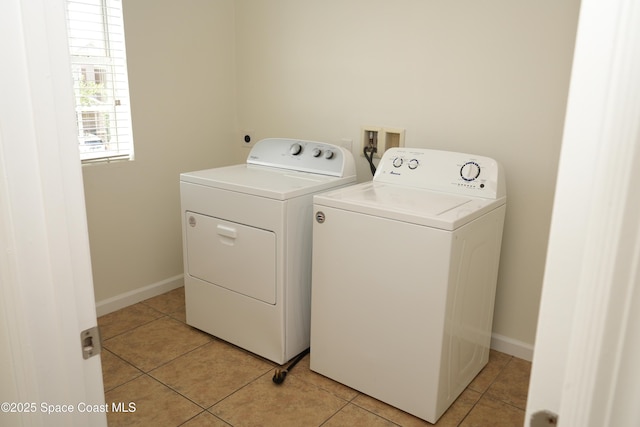1545 Litchfield Dr, Melbourne, FL 32904 - laundry room featuring washer and clothes dryer, light tile patterned floors, and baseboards