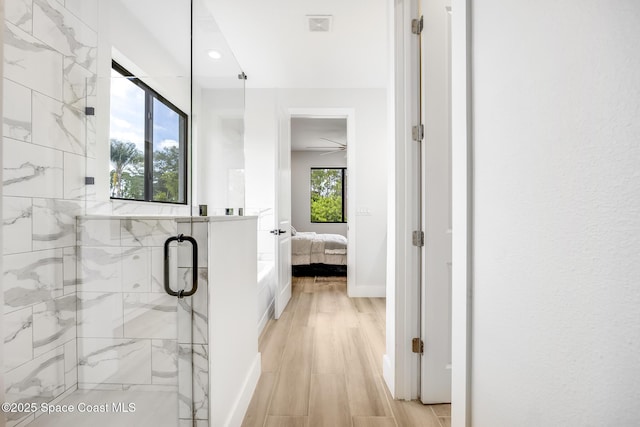 bathroom featuring an enclosed shower and hardwood / wood-style floors