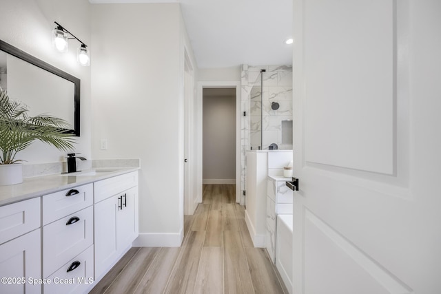 bathroom featuring vanity, shower with separate bathtub, and wood-type flooring