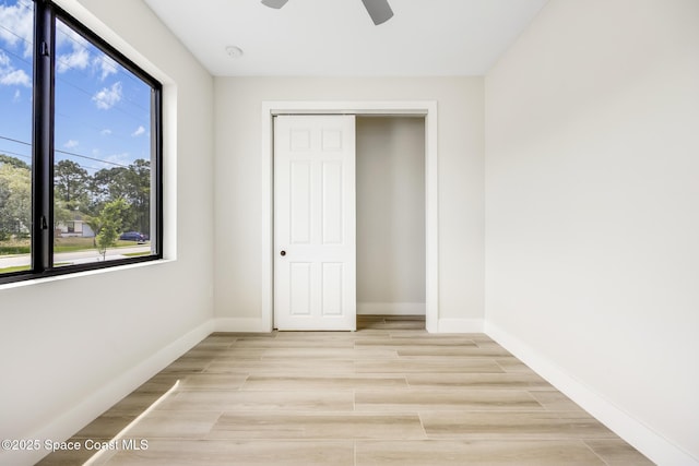 unfurnished bedroom with a closet and ceiling fan