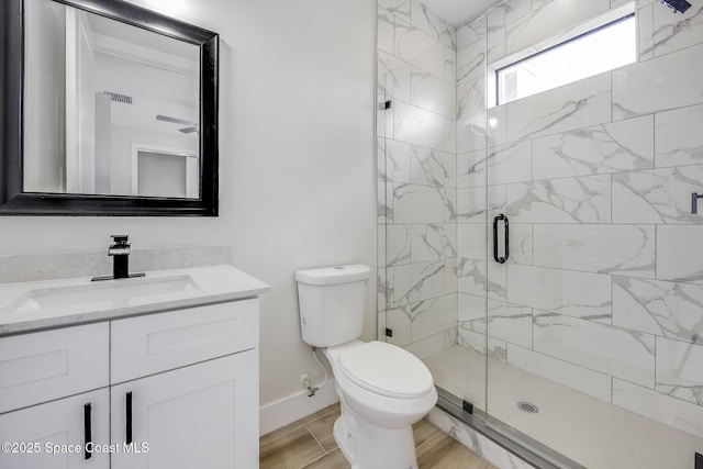 bathroom with an enclosed shower, vanity, hardwood / wood-style floors, and toilet