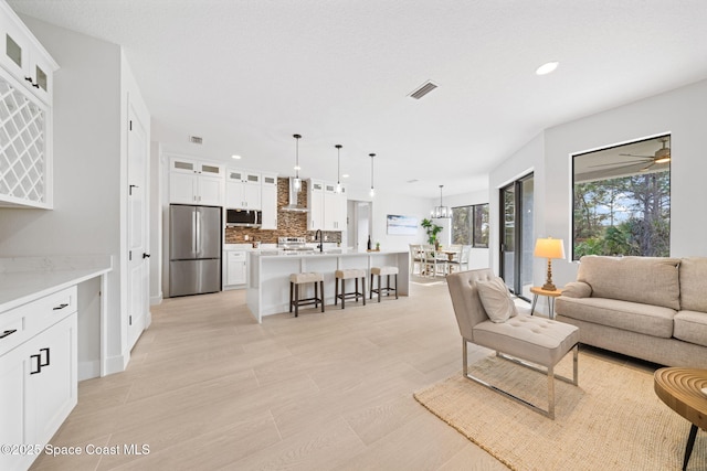 living room with sink and light hardwood / wood-style flooring