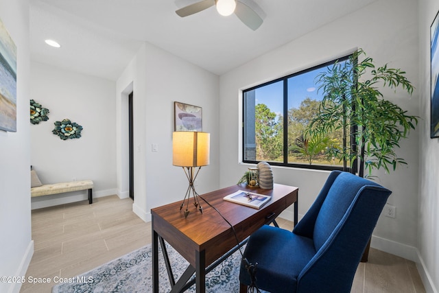 office area with light hardwood / wood-style floors and ceiling fan