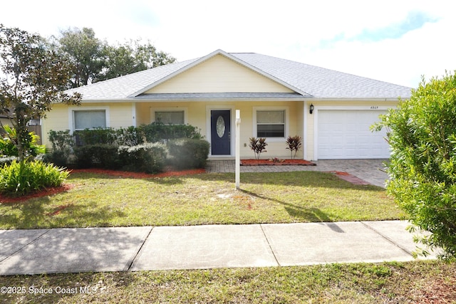 ranch-style house with a garage and a front yard