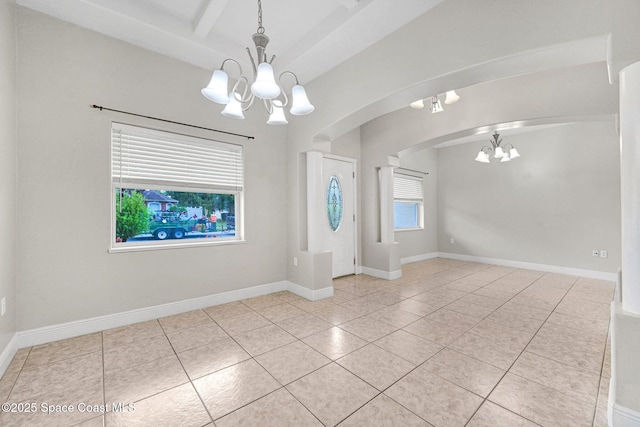 tiled entrance foyer featuring a notable chandelier and beamed ceiling