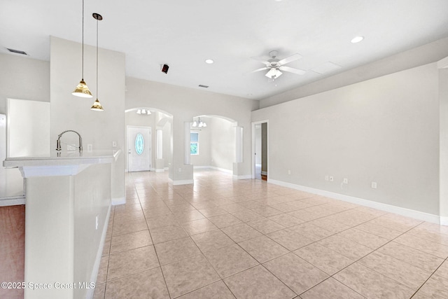 interior space with light tile patterned flooring and ceiling fan