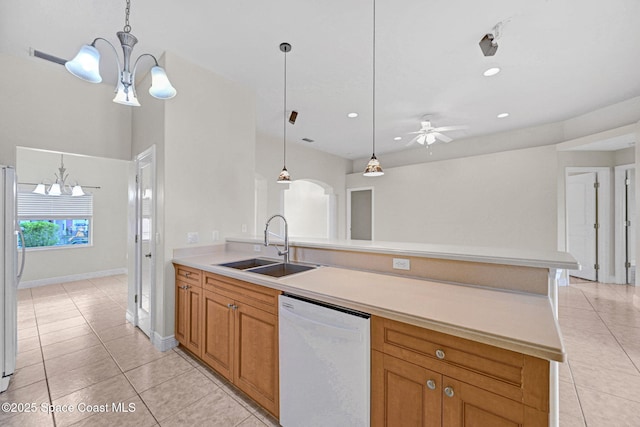 kitchen with light tile patterned flooring, sink, pendant lighting, and white appliances