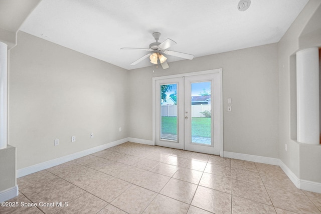 spare room with light tile patterned floors, french doors, and ceiling fan