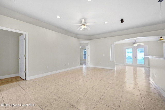 tiled spare room with ceiling fan