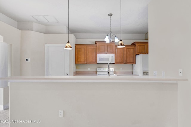 kitchen with white appliances and decorative light fixtures