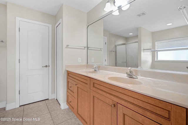 bathroom with tile patterned floors, an enclosed shower, and vanity