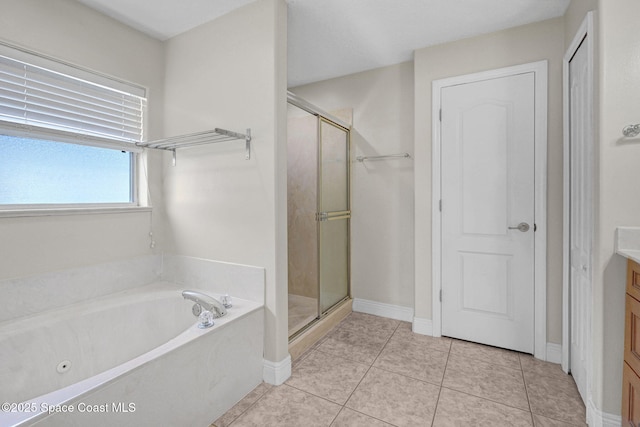 bathroom featuring vanity, plus walk in shower, and tile patterned flooring