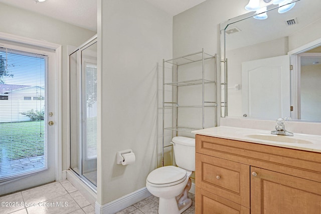 bathroom featuring tile patterned floors, toilet, a shower with shower door, and vanity