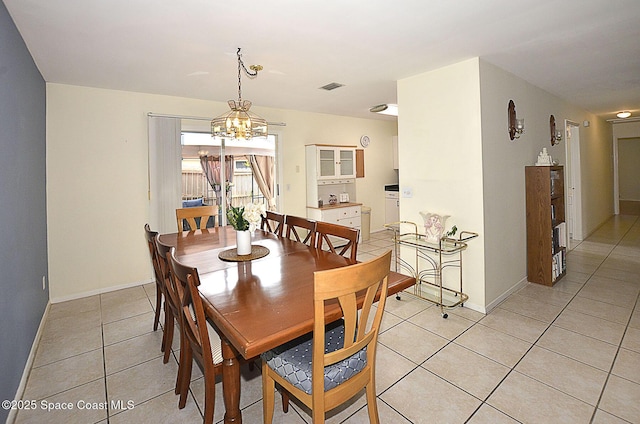 tiled dining area with an inviting chandelier