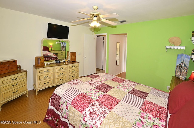 bedroom with ceiling fan and dark hardwood / wood-style floors