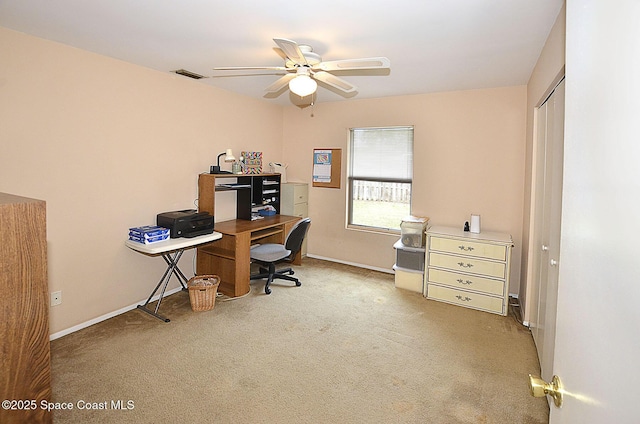 carpeted home office featuring ceiling fan