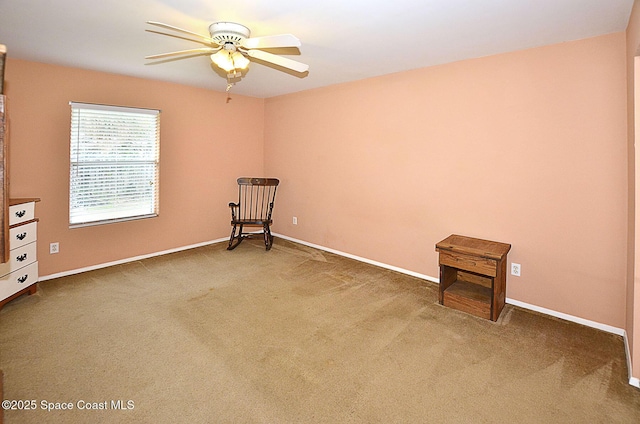 carpeted empty room featuring ceiling fan